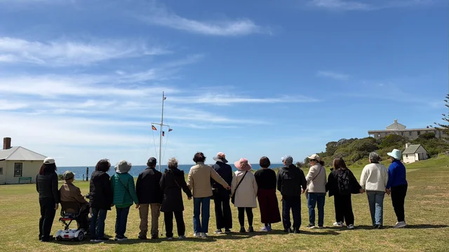 The outing group standing together and looking out across the water