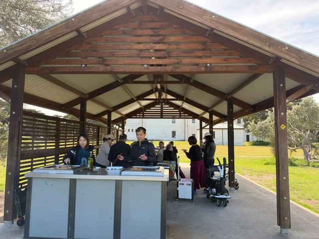 The VN Care Network outing group preparing food at an outdoor barbecue shelter